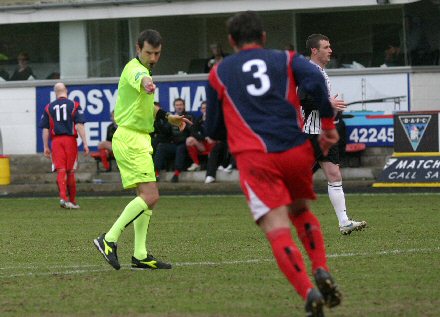 Referee Alan Muir points to the spot